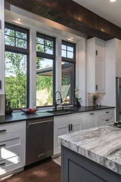 a kitchen with marble counter tops and stainless steel appliances