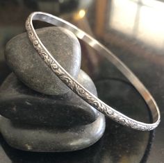 This listing is for one Sterling Silver Stacking Southwestern style floral Bangle Bracelet. This bangle is 3.55mm x 1.52mm thick and is sure to be a unique addition to your favorite stacking bangle bracelets! Lovely pattern All bangles are soldered, hammered, tumbled for hours and hand-polished just for you! My bangle sizes are available in the following sizes: Small - 2 1/4 inch diameter - Petite Adult 7 inch circumference Medium - 2 1/2 inch diameter - 8 inch circumference (common) Large - 2 3 Silver Bangles Design Silver Bangles Design For Women, Silver Bangle Bracelets Unique Modern, Bohemian Etched Sterling Silver Bangle, Southwestern Bangle Bracelet For Gift, Silver Bangle Bracelets Unique, Bangle Stacking, Silver Jewellry, Stacking Bangles, Bridal Jewelry Sets Brides