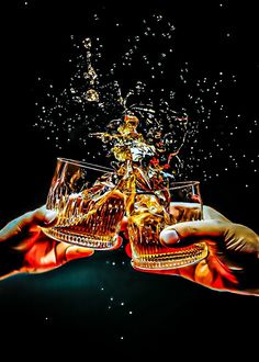 two hands holding glasses filled with liquid and bubbles in front of a black background full of stars