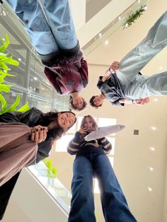 four people standing in a circle holding knives