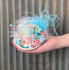 "THIS IS A MICRO MINI HAT...it will fit in the palm of your hand. A spot of tea? Perhaps a wee little cupcake. You'll get both on this little pretty fabric hat. The paper flower bouquet and lovely feathers add that extra feminine charm. Perfect for tea party atire. --------------------------------------------------------------------------- An elastic band is attached to keep it on your head. The band is meant to go behind your ears and rest at the nape of your neck (NOT UNDER YOUR CHIN). A few h Tea Cup Hat, Wedding Top Hat, Tea Party Attire, Cup Hat, Alice In Wonderland Mad Hatter, Wonderland Mad Hatter, Hat Tea Party, Mad Hatter Hat, Mini Hat