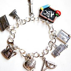 This charm bracelet features teacher/professor/mentor inspired Tibetan silver charms -a silver plated zinc alloy metal which is lead and nickel free. Each charm is attached to a silver tone bracelet that measures 7.5 inches in length. Charm School, Silver Charm Bracelet, Tibet, Silver Charms, Zinc Alloy, Silver Plate, Silver Plated, Jewelry Bracelets, Silver Tone