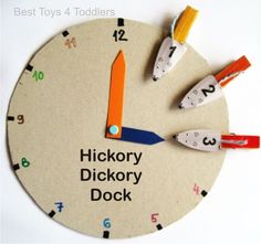 a clock made out of cardboard with scissors and numbers on the face that says hickory dickery dock