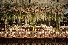 a long table is set with candles and flowers on it for an elegant wedding reception