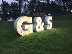 a sign that says g & s in the grass