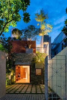 the entrance to a modern home surrounded by greenery