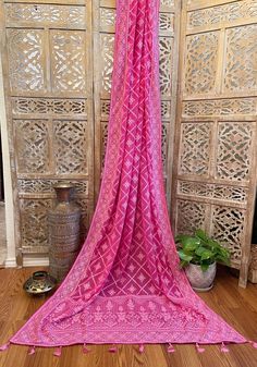 A very very pretty Chikankari saree in pure georgette in a lovely candy pink shade with all over jaal (barfi pattern) embroidery with mukaish work (embellishments). The pallu is short but features intricate designs. The entire saree has the same pattern from the very beginning of the saree except the portion you have to tuck in so that it doesn’t bulge. Entire saree is framed in cord piping, best quality satin falls are attached and picot stitching is done as well. The blouse piece is separated Pink Bandhani Print Pre-draped Saree For Festivals, Traditional Pink Saree With Sheer Dupatta, Pink Pre-draped Saree With Dupatta For Eid, Eid Pink Pre-draped Saree With Dupatta, Pink Cutdana Dupatta For Traditional Ceremonies, Pink Pre-draped Saree For Eid Ceremonies, Pink Chikankari Embroidery Pre-draped Saree, Traditional Style Pink Pre-draped Saree With Dupatta, Traditional Pink Pre-draped Saree With Dupatta