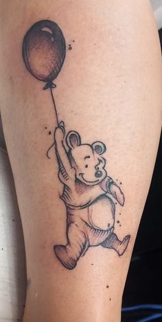 a black and white drawing of a bear with a balloon tattoo on the leg,