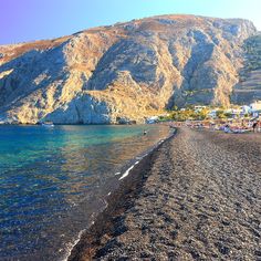 there is a beach with mountains in the background