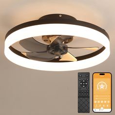 a ceiling fan with remote control next to an iphone