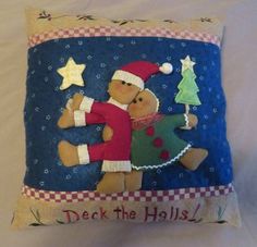 a decorative pillow with two teddy bears hugging each other and the words deck the holidays written on it