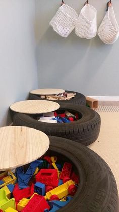 two large tires filled with toys in a room