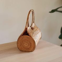 The Bali Rattan Wheel Handbag is the perfect accessory for any stylish woman. This beautiful, handmade rattan bag is made by skilled artisans in Bali, using natural materials to create a one-of-a-kind piece that is both fashionable and functional. The wheel design adds a unique touch to the classic rattan style, making it the perfect bag for everyday use or a night out. With its spacious interior and beautiful design, the Bali Rattan Wheel Handbag is sure to impress. Shop now and add a touch of Rattan Style, Rattan Handbags, Wheel Design, Woven Handbags, Rattan Bag, Perfect Bag, Decorative Wicker Basket, Stylish Women, Handmade Natural