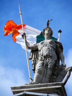 a statue with an orange and white flag on top