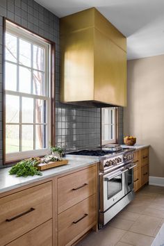 a kitchen with an oven, stove and counter top in the middle of the room