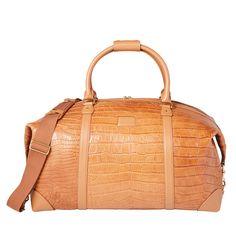 Built with Lucchese's own giant American alligator, this signature duffle totes your essentials in first class style. The fold-end construction allows for maximum packing space, which includes natural, water-resistant canvas lining, an interior zipper pocket and two open storage slots. High-end Travel Bags With Crocodile Pattern, High-end Crocodile Pattern Travel Bags, Luxury Textured Leather Travel Bag For Formal Occasions, Luxury Leather-lined Weekender Bag For Formal Occasions, Luxury Rectangular Luggage With Leather Lining, Classic Travel Bag With Crocodile Pattern, Luxury Cognac Duffle Bag For Travel, Luxury Cognac Weekender Bag With Leather Handles, Luxury Textured Leather Rectangular Weekender Bag