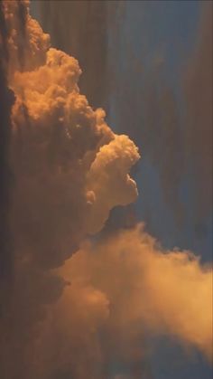 an airplane flying in the sky with clouds