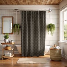 a bath room with a shower curtain and a rug on the floor in front of it