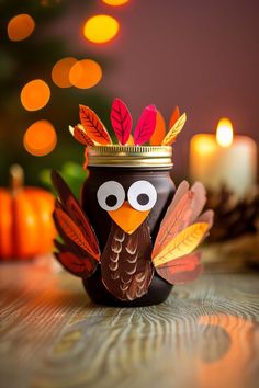 a decorated turkey jar with candles in the background