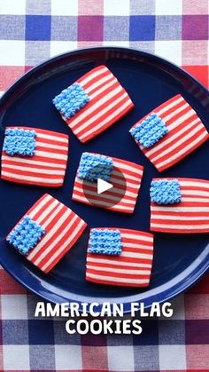 american flag cookies on a blue plate with red, white and blue icing in the shape of an american flag