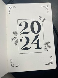 an open notebook with the numbers twenty and twenty on it