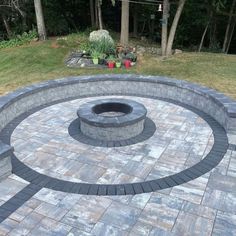 an outdoor fire pit surrounded by bricks