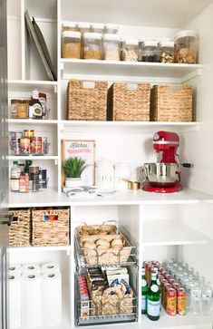 an organized pantry with lots of food and drinks in baskets on the shelves, along with other items