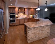 a large kitchen with an island in the middle