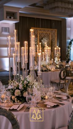 an elegant table setting with candles and flowers