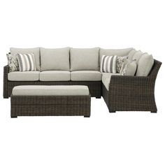 an outdoor sectional sofa with pillows and ottomans