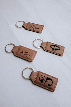 three leather keychains with the word willu written on them