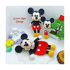 two crocheted mickey and minnie mouses on a doily next to a potted plant