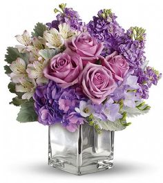 purple and white flowers in a square vase