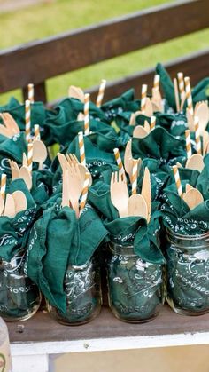 mason jars filled with forks and green napkins