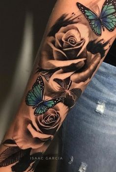 a woman's arm with roses and butterflies on it