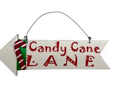 a candy cane lane sign hanging on a wall