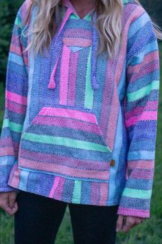 If you LOVE bright colors, this is the hoodie for you! With super cute color pops, it's vibrant and excentric, without being over the top! Wear it with some cozy black leggings, or dress it up with washed out jeans and vans! Either way, you'll be lookin' good! #bajahoodie #upcycle #recycle #handwoven #hippielifestyle #bajavibes #drugrug #cozy #bajaupcycle #handmade #ponchos #lifestyle #hoodie #adventure #adventurehoodie #boho #multipurpose #goodvibes #goodvibesonly #brightfashion #colorful Baja Hoodie Outfit Men, Crochet Baja Hoodie, Multicolor Hand Dyed Hooded Hoodie, Baja Sweater, Mexican Baja Hoodie, Jeans And Vans, Baja Hoodie, Hippie Lifestyle, Mexican Blanket