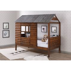 a child's bed with a wooden cabin like structure