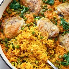 chicken and rice dish in a pan with a spoon