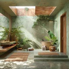 an indoor bathroom with plants and towels on the floor