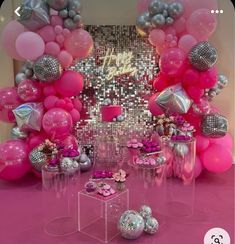 a pink and silver birthday party with balloons