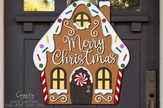 a door sign that says merry christmas with a gingerbread house and candy canes