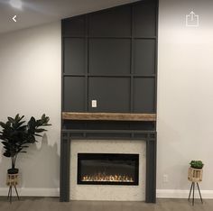 a living room with a fireplace and potted plants