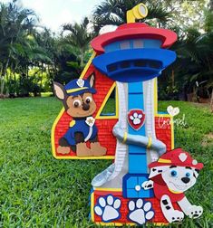 the paw patrol number four is on display in the grass next to a toy fire hydrant