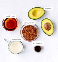 the ingredients for an avocado smoothie laid out on a white table top