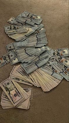 a pile of money sitting on top of a floor