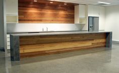 an empty office with wood paneling on the wall and counter top in front of it