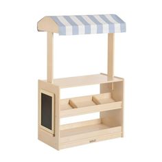 a small wooden dog house with a blue and white awning on the top shelf