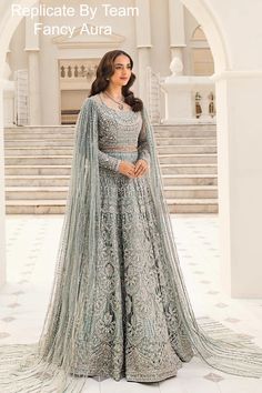 a woman in a blue and silver lehenga with the caption replica by team fancy aura