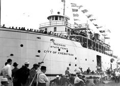 an old black and white photo of people standing on the deck of a large ship